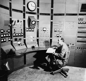Physicists Prints: Enrico Fermi (1901-1954), seated at control panel of a particle accelerator, in 1951