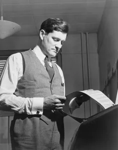 Eric Prints: Eric Sevareid (1912-1992), reads document from teletype
