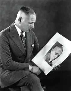 Erich Prints: Erich von Stroheim looking at a picture of himself, 1924
