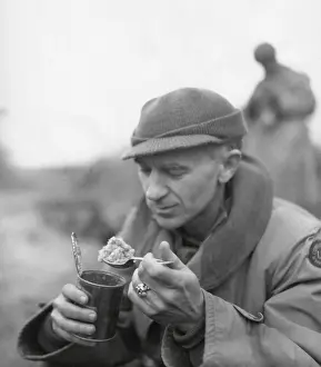 Ernie Prints: Ernie Pyle, war correspondent, eating his C rations