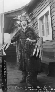 Spiritual Prints: Eskimo medicine man in mask and sick boy
