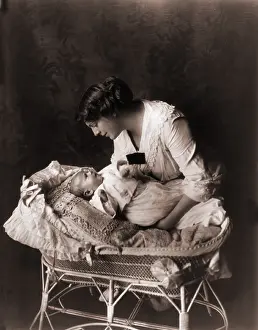 Edwardian Prints: Ethel Barrymore (1879-1959), leaning over the crib of her third child