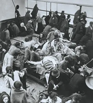 On Deck Prints: European immigrants huddled on the deck of a passenger ship sailing to America