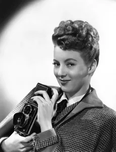 Evelyn Prints: Evelyn Keyes, with a Rolex camera, ca. mid-1940s