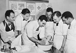 Brooklyn Prints: Expectant fathers bathing a doll during an infant care class at the Brooklyn Red Cross Headquarters