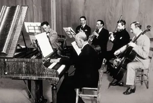 FALLA, Manuel de (1876-1946). Manuel de Falla playing the harpsichord accompanied by other musicians during a recording in 1927. AISA/Everett Collection**US SALES ONLY**
