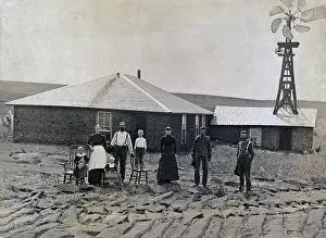 Settlers Prints: A farm family standing in front of sod house and windmill. Coburg, Nebraska 1885