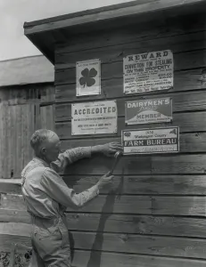 Hammer Prints: Farmer attaches another membership sign to his barn