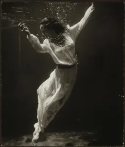 Underwater Prints: Fashion model underwater in dolphin tank