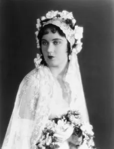 Wedding Dress Prints: Fay Wray, modeling a lace wedding gown trimmed in gardenias and orange blossoms, ca. 1928