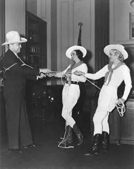 Texas Prints: FBI Director J. Edgar Hoover is lassoed by Texas Rangerettes at the Texas Expo