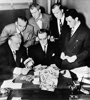 Evidence Prints: Federal and State men looking at part of $100