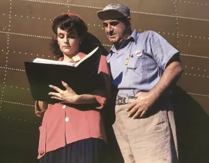Engines Prints: Female inspector confers with a co-worker when checking the center wings for C-47 transport planes