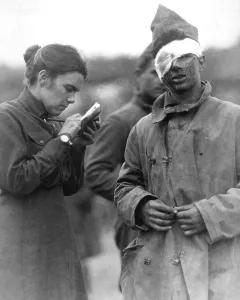 December Prints: Female Salvation Army worker writing a letter to the home folks for the wounded World War I soldier