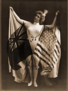 Vaudeville Prints: Female vaudeville performer in white body suit, wearing a cape of U.S. and British flags