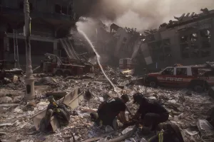 Skyscraper Prints: Fire fighters set up a hose amid smoking rubble following September 11th terrorist attack on World Trade Center