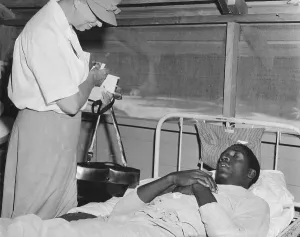 Liberals Prints: First Lady Eleanor Roosevelt visits a African American soldier in a South Pacific military hospital