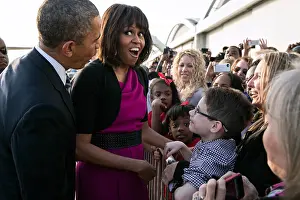 Cameras Prints: First Lady Michelle Obama reacts while talking with people along a rope line