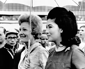 Manila Prints: First Lady Pat Nixon (left) and Imelda Marcos stand under an umbrella at Manila airport