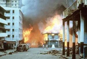 Latin American Prints: Flames engulf buildings in Panama City during urban combat between the Panamanian Defense Force and U