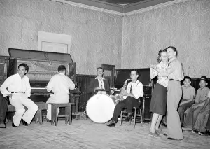 Drums Prints: Folk Music. Orchestra and dancers at payday dance