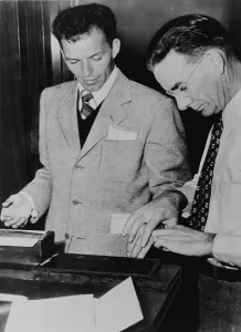 Swing Prints: Frank Sinatra (1915-1998) getting fingerprints taken following application for permission to carry a gun