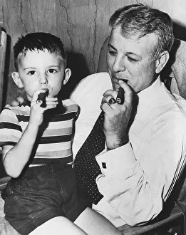 Sitting On Lap Prints: Frank Wilson, secretary- treasurer of Fulton-DeKalb Hospital Authority with five-year-old Jimmy Wingo