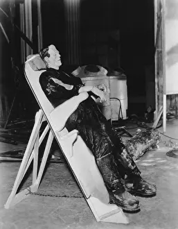 Images Dated 22nd July 2015: FRANKENSTEIN, Boris Karloff on a reclining board between scenes on set, 1931