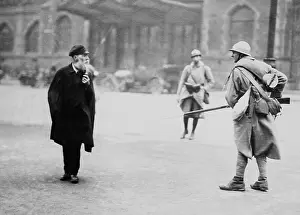 Helmets Prints: French soldier posted in front of the main Essen stations intimidates a elderly civilian