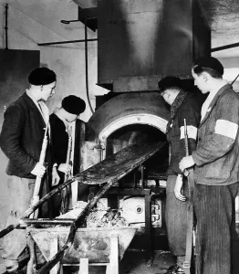 Furnace Prints: French soldiers examine the furnace used to burn dead prisoners at the Vosges concentration camp near Natzwiller
