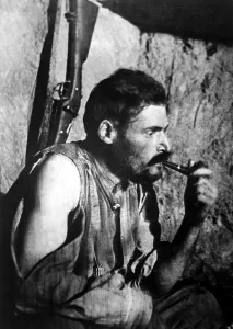 Trench Warfare Prints: French World War I soldier smoking a pipe and resting after battle. 1914-1918