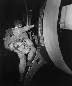 Paratroopers Prints: Fully loaded U.S. paratrooper climbs into a glider that will land behind the Normandy beaches