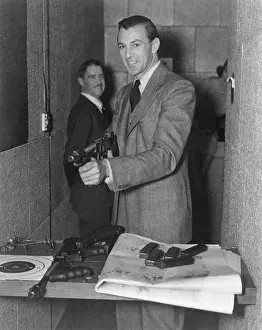 Gary Prints: Gary Cooper with submachine in FBI Gun Range. Ca. 1940. (BSLOC_2014_7_81)