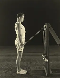 T Shirt Prints: Gene Tunney, World Heavy Weight Champion lifting weights on pulleys