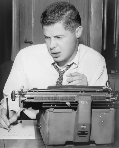 Screenwriter Prints: George Axelrod (1922-2003), playwright and screenwriter, seated at typewriter