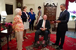 Lcgr1506 Prints: George H. W. and Barbara Bush present President Barack Obama with a pair of colorful socks