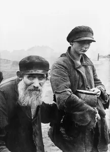 Young Man Prints: German photograph of two impoverished Jews in Kutno, Poland. 1942