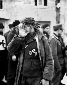 Wehrmacht Prints: German prisoner captured during the Battle of the Bulge declines to be photographed