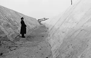 Fortifications Prints: German soldier in an anti-tank ditch on the Atlantic Wall north of Caen