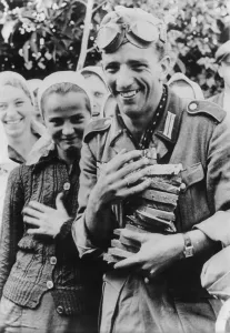 Ukraine Prints: German soldier holding an armful of sliced bread with several young Ukrainian women