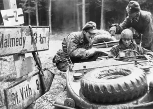 Belgium Prints: German SS troops with the 1st Panzer division check a highway sign at an Ardennes crossroad
