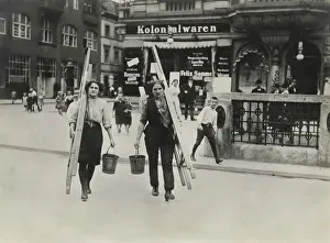 Trousers Prints: German women window cleaners dressed for work carry their tools in a Berlin street in World War 1