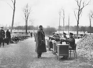Records Prints: Gestapo officials recording data on incoming prisoners at a German concentration camp