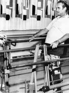 Physical Therapy Prints: Gov. George Wallace walks in rehabilitation with the assistance of leg braces and parallel bars