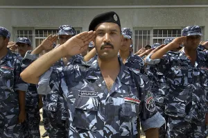Nation Building Prints: Graduates of the Iraqi Police Academy's salute during the commencement ceremony in Salman Pak Iraq