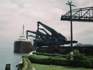 Commodities Prints: Great Lakes freighter unloading iron ore at the Pennsylvania Railroad ore docks in Cleveland Ohio