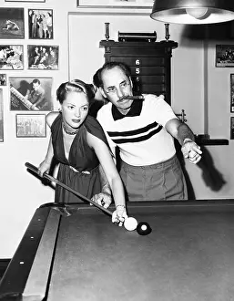 Vaudeville Prints: Groucho Marx at home playing billiards with his young wife