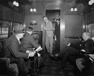 Electricity Prints: Group of men listening to a radio in a railroad lounge car