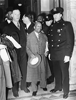 Communes Prints: Guarded by a policeman, Father Divine, leaves Felony Court, NYC, April 30, 1937