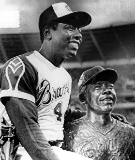 Aaron Prints: Hank Aaron poses with bust of himself on eve of breaking Babe Ruth's career home run record of 714